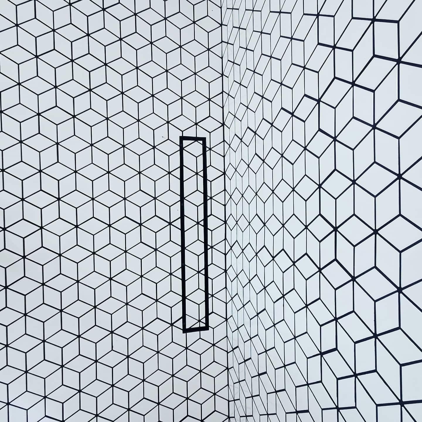 Geometric black and white mosaic tile corner accent with niche