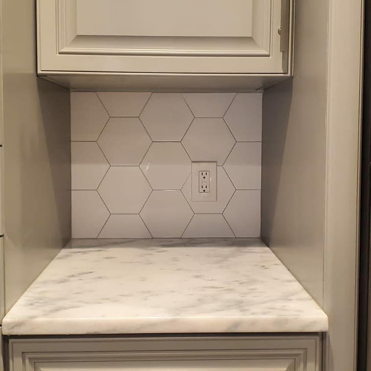 Hexagon marble tile backsplash with marble countertop
