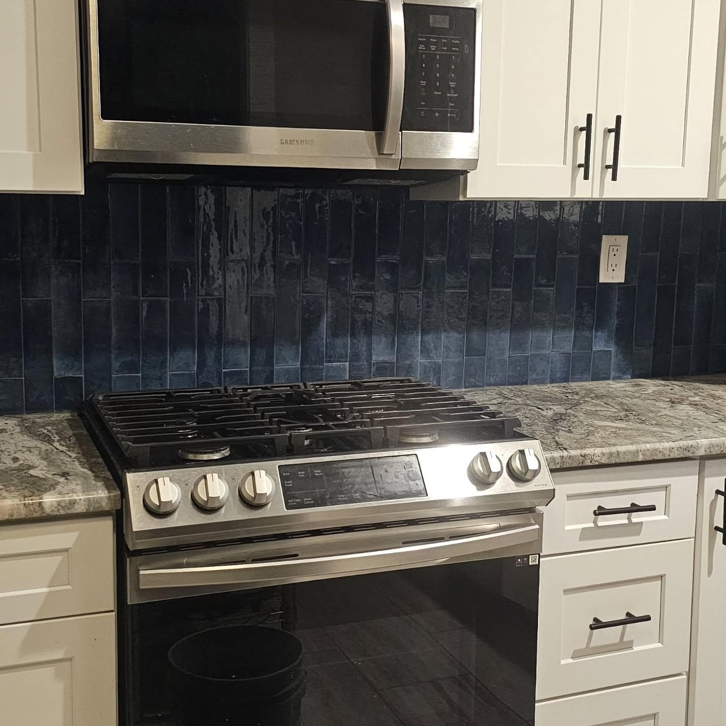 Deep navy vertical tile kitchen backsplash