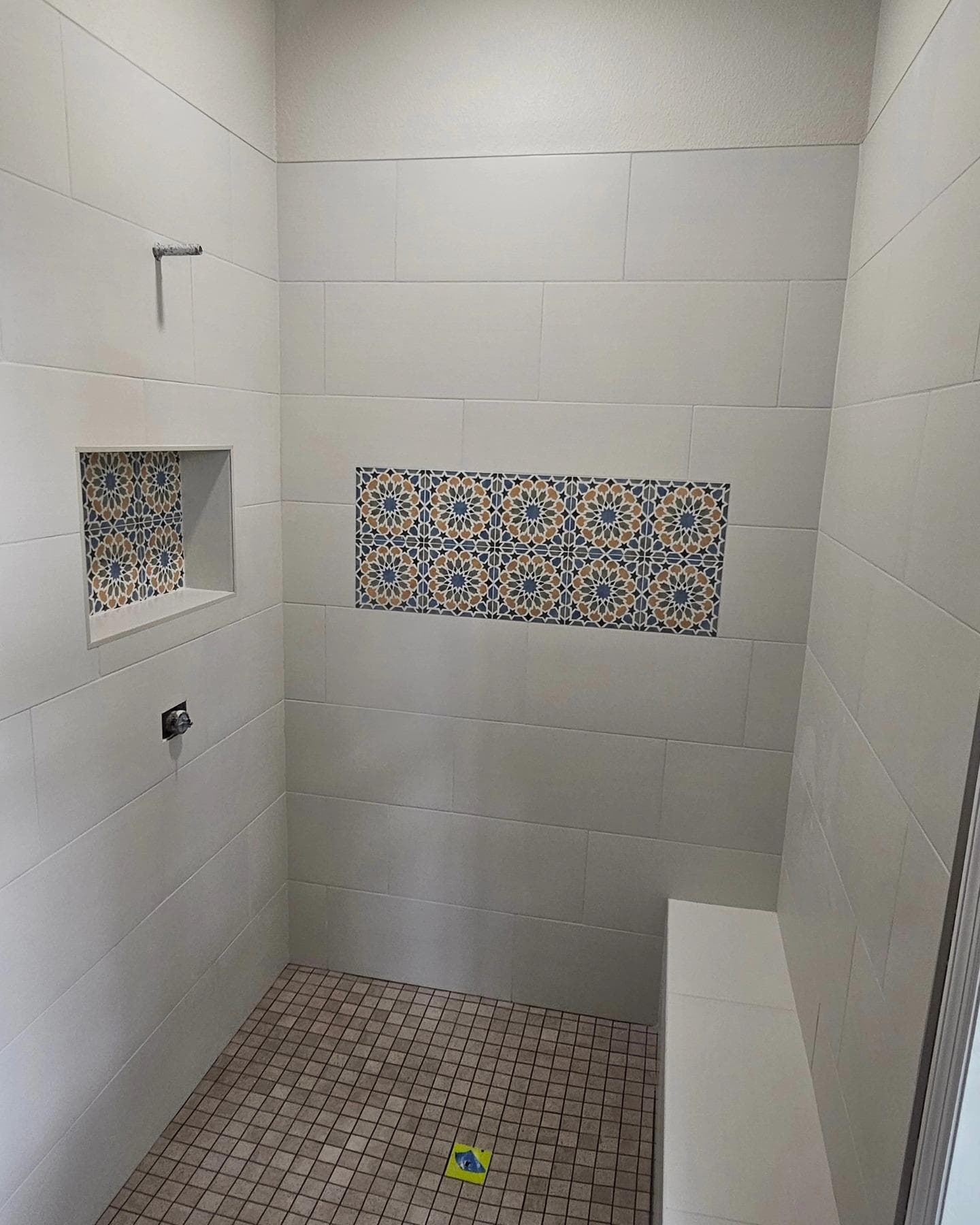 Shower with Moroccan-pattern tile accent niche