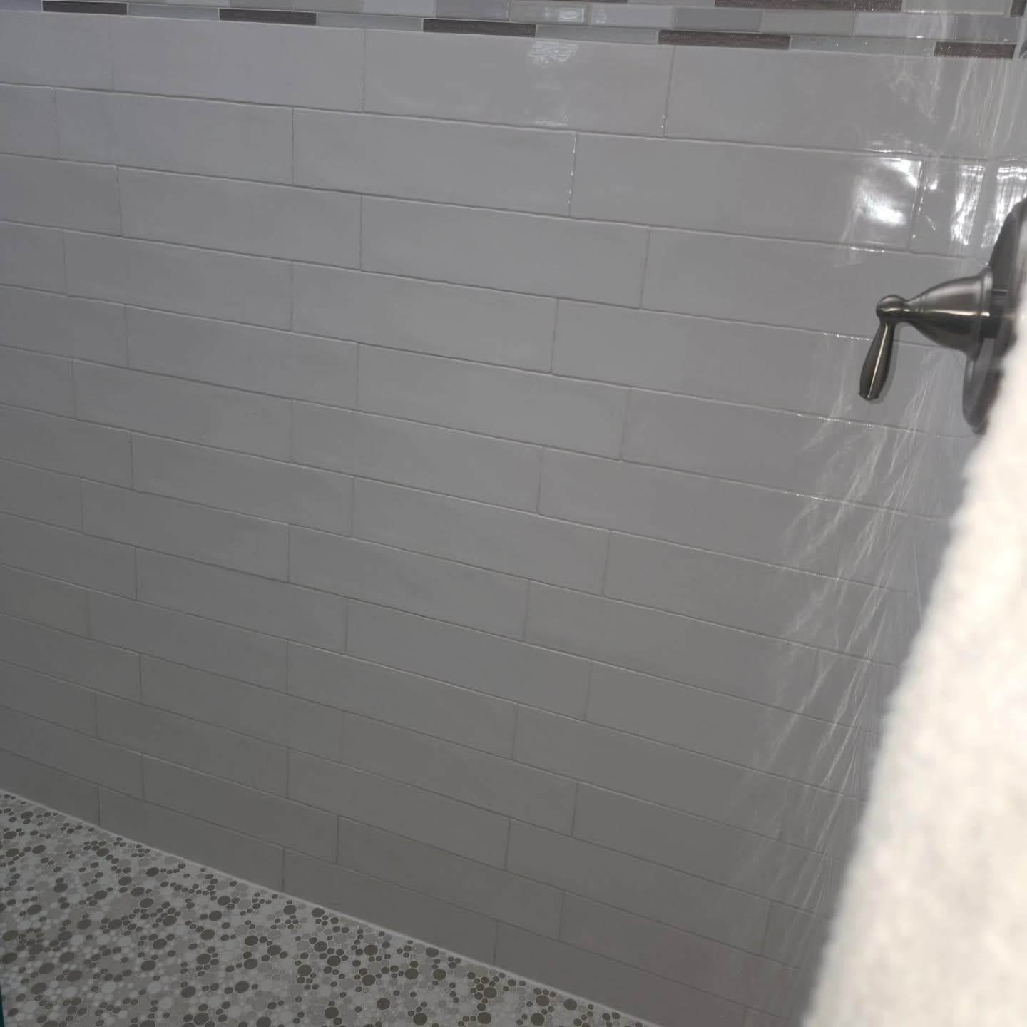 Subway tile shower wall with chrome fixture